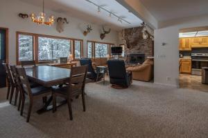 a dining room and living room with a table and chairs at RMR: Stock House in Teton Village in Teton Village