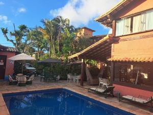a house with a swimming pool in front of a house at Pousada Mar a Mar in Búzios +35 photos