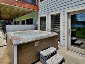 a hot tub sitting outside of a house at Paravel in Swanton