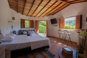 a bedroom with a large bed and a couch at Aires de encanto in San Gil