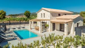 a villa with a swimming pool and a house at Petra Natura Villa in Zakynthos Town
