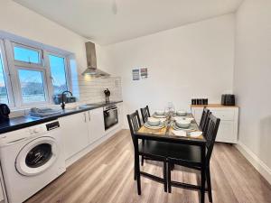 a kitchen with a table and chairs and a sink at Convenient Private Single Room 30 Min to Central in Wembley