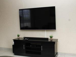 a flat screen tv hanging on a wall at Tshukudu e Ntsho in Mogwase