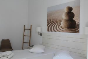 a room with a picture of a stack of rocks at Aegeo Inn in Antiparos