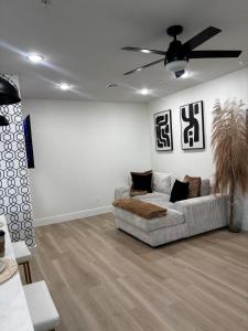 a living room with a couch and a ceiling fan at Houston Luxury 2bd Apartment in Houston