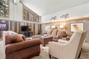 a living room with two couches and a tv at RMR: Elkhorn Lodge Home in Teton Village in Teton Village