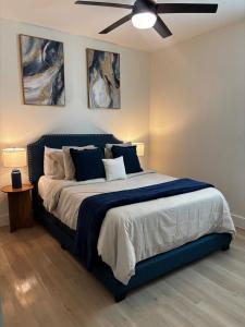 a bedroom with a large bed with a ceiling fan at Houston Luxury 2bd Apartment in Houston