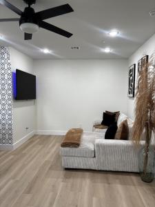 a living room with a couch and a ceiling fan at Houston Luxury 2bd Apartment in Houston