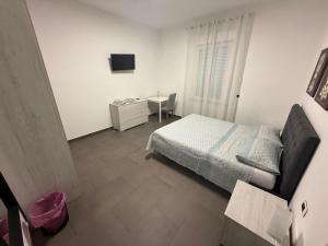 a small bedroom with a bed and a desk at La terrazza guest house in Ponsacco