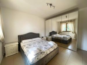 a bedroom with two beds and a large mirror at Casa Junea in Maccarese