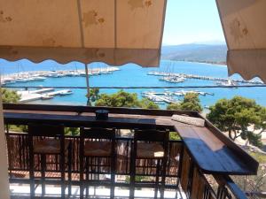a view of a harbor from a balcony with a bench at Elmar House in Paralio Astros