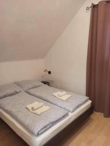 a bedroom with a bed with two towels on it at Barackvirág in Balatongyörök