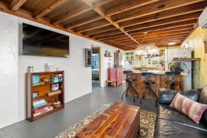 a living room with a couch and a table at The Pink House in Kill Devil Hills