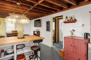 a kitchen with a counter and a dining room at The Pink House in Kill Devil Hills +16 photos