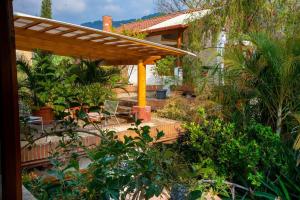 a backyard with a wooden deck with a pergola at David's Den Atitlán in Panajachel