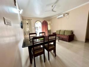 a dining room and living room with a table and chairs at Beachside luxury getaway in Cana