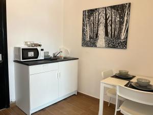 a small kitchen with a microwave and a table at Equipped studio in Tetouan in Tétouan