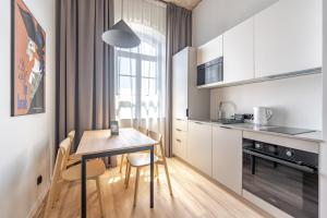 a kitchen and dining room with a table and chairs at Noli Gdansk Old Town in Gdańsk