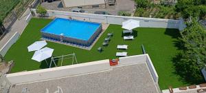 an overhead view of a pool with chairs and umbrellas at Tenuta Coppola in Gragnano