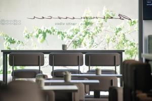 a row of tables and chairs in a restaurant at Smarthotel Brenner24 - Self Check In in Brennero