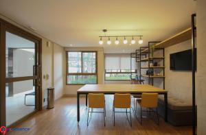 a dining room with a wooden table and chairs at Studios no Morumbi in Sao Paulo