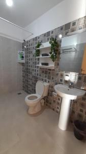 a bathroom with a toilet and a sink at Rouge Azur Saidia in Saïdia
