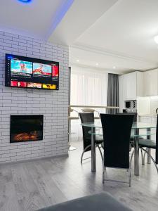 a living room with a fireplace and a dining room at Premium Jumbo Apartment in Chişinău