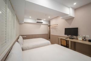 Voodi või voodid majutusasutuse 慶爾喜旅館長沙館Cheers Loft Self Check-in Hotel toas