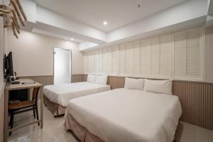Voodi või voodid majutusasutuse 慶爾喜旅館長沙館Cheers Loft Self Check-in Hotel toas