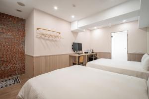 Voodi või voodid majutusasutuse 慶爾喜旅館長沙館Cheers Loft Self Check-in Hotel toas