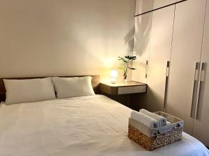 a bedroom with a white bed with a chair on it at Bonded in Hanoi