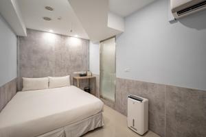 Voodi või voodid majutusasutuse 慶爾喜旅館長沙館Cheers Loft Self Check-in Hotel toas