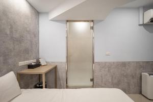 Voodi või voodid majutusasutuse 慶爾喜旅館長沙館Cheers Loft Self Check-in Hotel toas