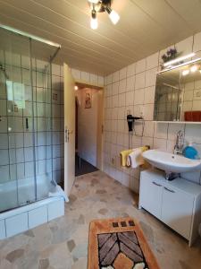 a bathroom with a tub and a sink and a shower at Bad Hindelang in Bad Hindelang +50 photos