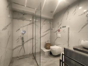 a bathroom with a shower and a toilet and a sink at Luxury Living Peramos in Néa Péramos +31 photos