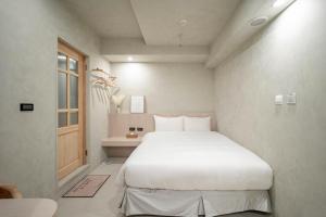 Voodi või voodid majutusasutuse 慶爾喜旅館長沙館Cheers Loft Self Check-in Hotel toas