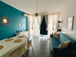 a blue living room with a table and a couch at Surfing Ocean View Appartment in Sal Rei