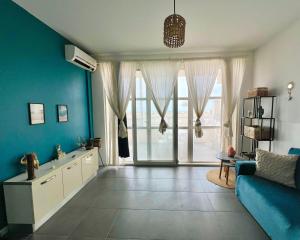 a living room with blue walls and a blue couch at Surfing Ocean View Appartment in Sal Rei