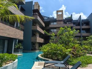 a view of a building with a swimming pool at Paramar Black Condominio en Tulum in Tulum