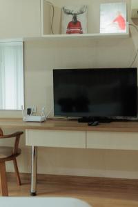 a large flat screen tv sitting on top of a table at Stay Classy Heart Of Nimman in Chiang Mai