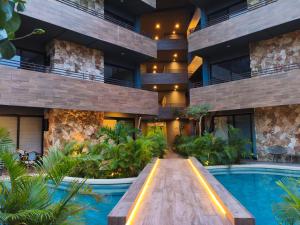 an exterior view of a building with a swimming pool at Paramar Black Condominio en Tulum in Tulum