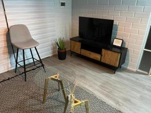 a room with a television and a chair and a table at Casa equipada Vallenar in Huasco