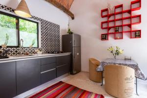 a kitchen with a table and a refrigerator at Concept House in Banda +32 photos