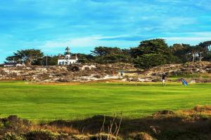 a person is flying a kite in a field at 3976 Mirka's Beach House home in Pacific Grove
