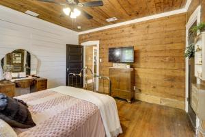 a bedroom with wooden walls and a bed in a room at 1925 Craftsman Bungalow - 1 Mi to Dtwn Waxahachie! in Waxahachie