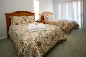 a bedroom with two beds with white towels on them at 37 Davis Love in Fripp Island +23 photos