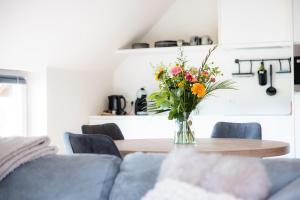 WingeneDe Weldoeninge的客厅桌子上的花瓶里的花