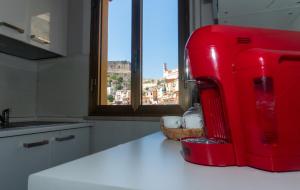 a red refrigerator sitting on top of a kitchen counter at LuMar in Scilla