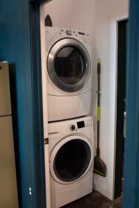 a washer and dryer stacked on top of each other at Downtown Lynchburg, Vintage Courtyard Loft, Va in Lynchburg