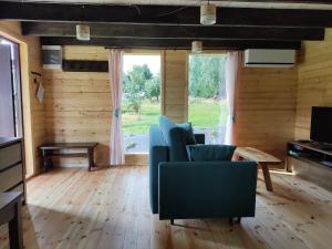 a living room with a couch and a table at Domek Izerskie Gaje in Wojcieszyce
